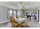 Cozy dining room with a ceiling fan, and dining table with seating for six, adjoins the living room at 6323 Wilora Lake Rd, Charlotte, NC 28212