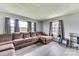 Comfortable living room featuring a large sectional sofa, neutral wall colors, and natural light from the windows at 6323 Wilora Lake Rd, Charlotte, NC 28212
