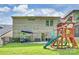 Expansive backyard with a patio seating area, playset, and lush lawn, ideal for outdoor activities at 6618 Vizcaya Ct, Charlotte, NC 28226