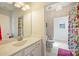 Well-lit bathroom boasting stylish tile, a spacious vanity, and a decorative shower curtain at 6618 Vizcaya Ct, Charlotte, NC 28226