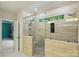 A modern bathroom features a glass-enclosed shower with a seat, neutral cabinets, and granite countertop at 6618 Vizcaya Ct, Charlotte, NC 28226