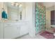 Bright bathroom featuring a double vanity, a decorative shower curtain, and modern finishes at 6618 Vizcaya Ct, Charlotte, NC 28226