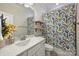 Charming bathroom with decorative shower curtain, a white vanity, and decorative shelving at 6618 Vizcaya Ct, Charlotte, NC 28226