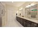 A modern bathroom features a double sink vanity, dark wood cabinets, granite countertop and a glass-enclosed shower at 6618 Vizcaya Ct, Charlotte, NC 28226