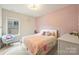 Bright bedroom featuring a large window and colorful decor, perfect for a room at 6618 Vizcaya Ct, Charlotte, NC 28226