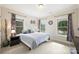 Cozy bedroom with neutral decor, two windows, and a comfortable bed at 6618 Vizcaya Ct, Charlotte, NC 28226