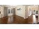 Elegant dining room featuring hardwood floors, modern chandelier, and wainscoting detail at 6618 Vizcaya Ct, Charlotte, NC 28226