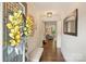 Inviting home entryway with hardwood floors, neutral paint, decorative wreath, and a glimpse into the living area at 6618 Vizcaya Ct, Charlotte, NC 28226