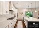 Bright kitchen features white cabinetry, stainless steel appliances, and an island with bar seating at 6618 Vizcaya Ct, Charlotte, NC 28226