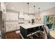 Bright kitchen features white cabinetry, an island with bar seating, and stainless steel appliances at 6618 Vizcaya Ct, Charlotte, NC 28226