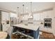 Modern kitchen featuring white cabinets, subway tile backsplash, stainless steel appliances, and an island with seating at 6618 Vizcaya Ct, Charlotte, NC 28226