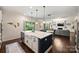 Kitchen with island, open to living room, offers stainless appliances and sliding glass doors to backyard at 6618 Vizcaya Ct, Charlotte, NC 28226