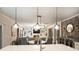 Open concept kitchen flows into the living room and features pendant lights and island seating at 6618 Vizcaya Ct, Charlotte, NC 28226