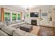 Comfortable living room featuring a fireplace, built-in cabinets, large windows, and plush sofa at 6618 Vizcaya Ct, Charlotte, NC 28226