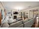 Open-concept living room with hardwood floors, fireplace, built-ins, and a view of the dining area at 6618 Vizcaya Ct, Charlotte, NC 28226