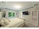 Main bedroom featuring tray ceilings, neutral carpet, and a window overlooking the backyard at 6618 Vizcaya Ct, Charlotte, NC 28226