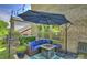Cozy patio with comfortable seating, string lights, and a view of the landscaped backyard at 6618 Vizcaya Ct, Charlotte, NC 28226