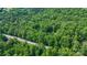 An aerial shot of a secluded home surrounded by lush trees and green grass at 715 Potneck Rd, Salisbury, NC 28147