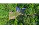 An aerial shot of a secluded home surrounded by lush trees and green grass at 715 Potneck Rd, Salisbury, NC 28147
