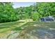 Backyard shot showcasing large grassy yard with fire pit, seating, and a partial view of the home at 715 Potneck Rd, Salisbury, NC 28147