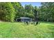 This backyard features a lush lawn with fire pit, outdoor seating, and an RV at 715 Potneck Rd, Salisbury, NC 28147