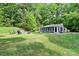 Expansive backyard features lush green grass, fire pit, and seating, perfect for outdoor gatherings at 715 Potneck Rd, Salisbury, NC 28147