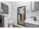 Bathroom featuring a convenient laundry area, sleek vanity, and modern fixtures, offering functionality and style at 715 Potneck Rd, Salisbury, NC 28147