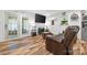 Inviting living room with a plush recliner, mounted TV, and plenty of natural light streaming through the window at 715 Potneck Rd, Salisbury, NC 28147