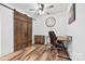 Functional home office with a rustic barn door, modern desk, and decorative shelving at 715 Potneck Rd, Salisbury, NC 28147