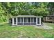 Relaxing sunroom with multiple screened windows and stone patio, ideal for enjoying the outdoors at 715 Potneck Rd, Salisbury, NC 28147