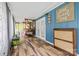 Inviting sunroom with a cozy swing bed, blue wood paneling, and beautiful wood-look flooring, creating a serene retreat at 715 Potneck Rd, Salisbury, NC 28147