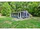 Charming sunroom featuring screened windows, stone patio, and outdoor seating, perfect for relaxing in nature at 715 Potneck Rd, Salisbury, NC 28147