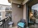 Relaxing balcony with a cozy chair and small table overlooking the community at 718 W Trade St # 704, Charlotte, NC 28202