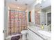 Bathroom featuring granite countertops, tile flooring, and a decorative shower curtain at 718 W Trade St # 704, Charlotte, NC 28202