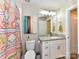 Bright bathroom featuring granite countertops, modern fixtures, and decorative shower curtain at 718 W Trade St # 704, Charlotte, NC 28202