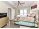 Bedroom showcasing natural light, ceiling fan, ample closet space and hardwood flooring at 718 W Trade St # 704, Charlotte, NC 28202