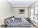 Inviting bedroom features a large window and a comfortable-looking bed and stylish side tables at 718 W Trade St # 704, Charlotte, NC 28202
