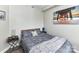Cozy bedroom features an ocean view painting and side tables with stylish lamps at 718 W Trade St # 704, Charlotte, NC 28202