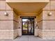 Gateway Plaza entrance with double glass doors framed by brick and elegant lighting fixtures at 718 W Trade St # 704, Charlotte, NC 28202