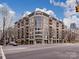Modern multi-story condo building boasts brick facade, large windows, and balconies on a city street at 718 W Trade St # 704, Charlotte, NC 28202