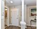 Hallway with wood floors and neutral walls leading to a bathroom with an ornate shower curtain at 718 W Trade St # 704, Charlotte, NC 28202