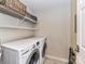Practical laundry room features modern LG washer and dryer units with storage shelves above at 718 W Trade St # 704, Charlotte, NC 28202