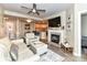 Inviting living room features a fireplace, flatscreen, modern ceiling fan, and open view to the kitchen at 718 W Trade St # 704, Charlotte, NC 28202