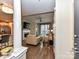 Open-concept space with a fireplace, a TV, leather furniture, and a door to a balcony at 718 W Trade St # 704, Charlotte, NC 28202
