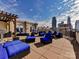 Enjoy outdoor living with a grill, comfortable seating, and city views from the roof top deck at 718 W Trade St # 704, Charlotte, NC 28202