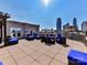 Amazing rooftop deck features lounge seating with fire pit, outdoor grill and spectacular city skyline views at 718 W Trade St # 704, Charlotte, NC 28202