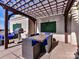 Rooftop deck features a grill, dining table and pergola covered seating area with exterior decoration at 718 W Trade St # 704, Charlotte, NC 28202