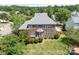 Aerial view of a beautiful brick home featuring a well-maintained backyard and mature trees at 7525 Blackgum Falls Ct, Huntersville, NC 28078