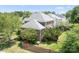 Brick home with backyard featuring mature trees, partial fence, and a lush green lawn at 7525 Blackgum Falls Ct, Huntersville, NC 28078
