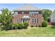Brick house backyard featuring a well-maintained lawn and a charming deck, ideal for relaxation and entertainment at 7525 Blackgum Falls Ct, Huntersville, NC 28078